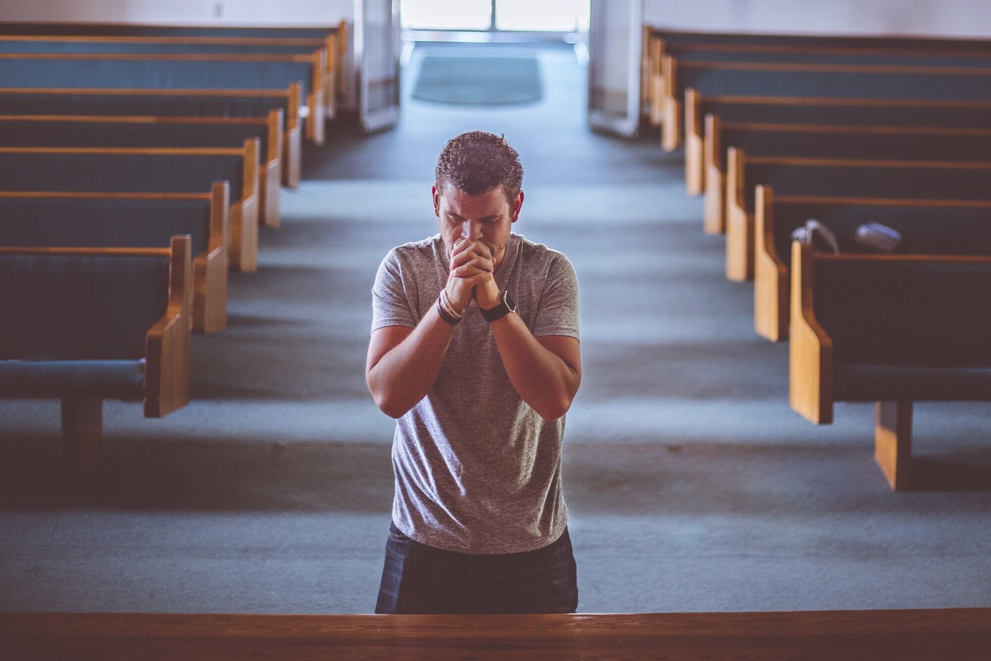 man-praying-church